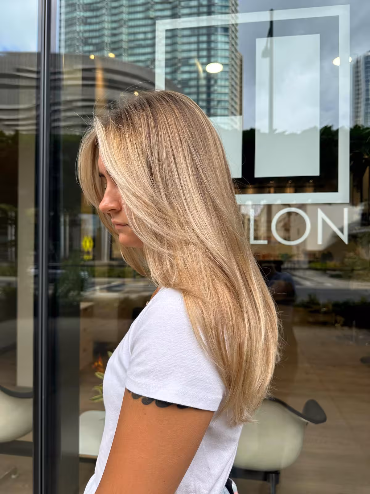 Long golden blonde layered hair with face-framing layers, side view - blonde highlights Honolulu